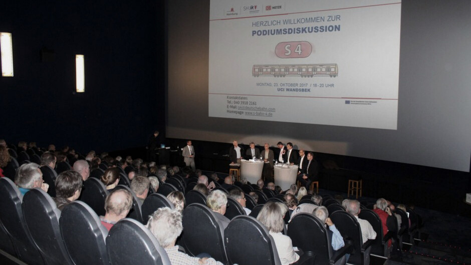 Panel discussion in a cinema auditorium